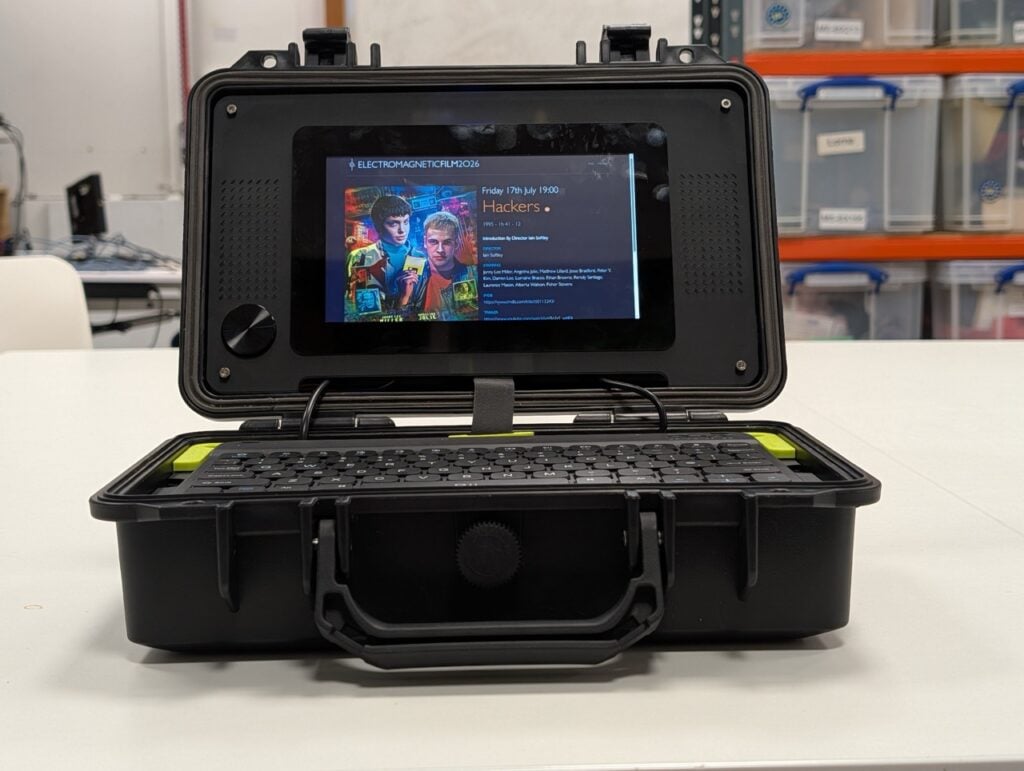 Open cyberdeck case showing the internal board, power components, and cable routing.